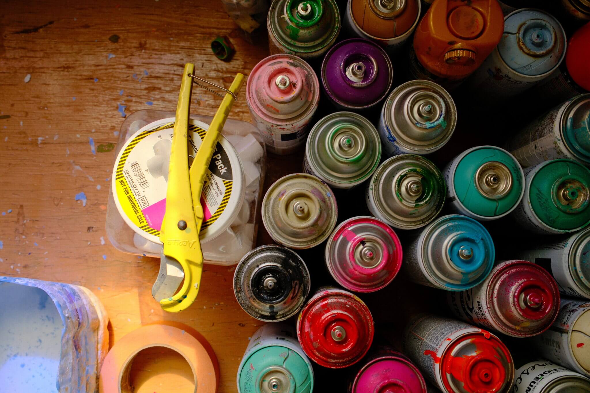 Cans of colorful spray paint can be found at Mauro's studio in San Antonio