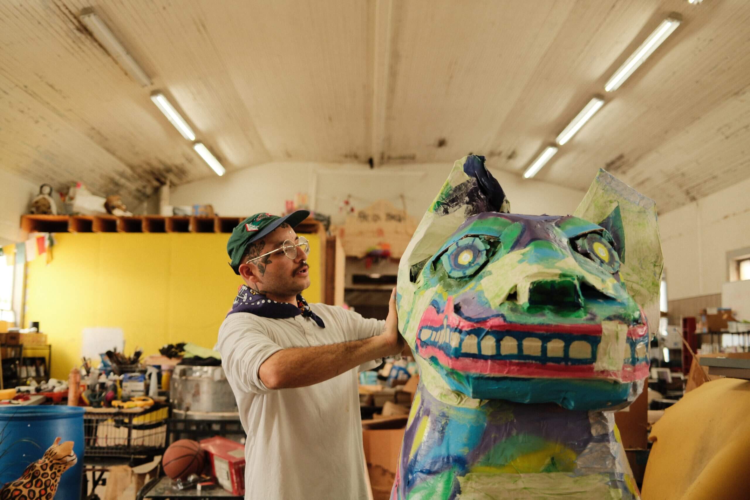 San Antonio artist Mauro de la Tierra in his studio near Pearl decorating an alebrije statue for dia de los muertos.